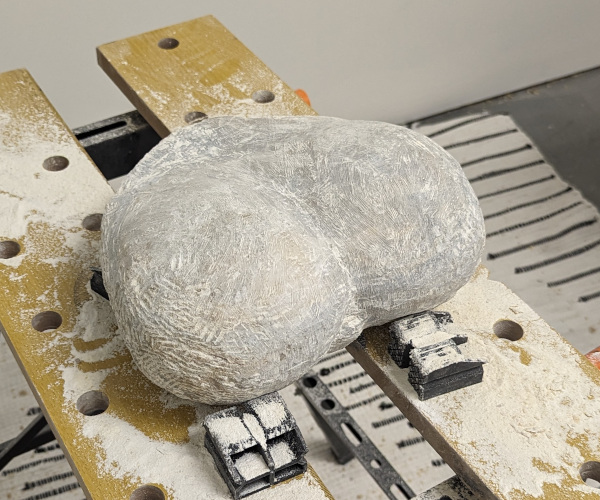 an abstract sculpture made from alabaster. it resembles a heart and a butt