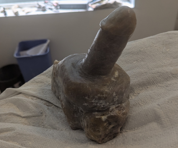 a sculpture made from alabaster featuring an erect penis